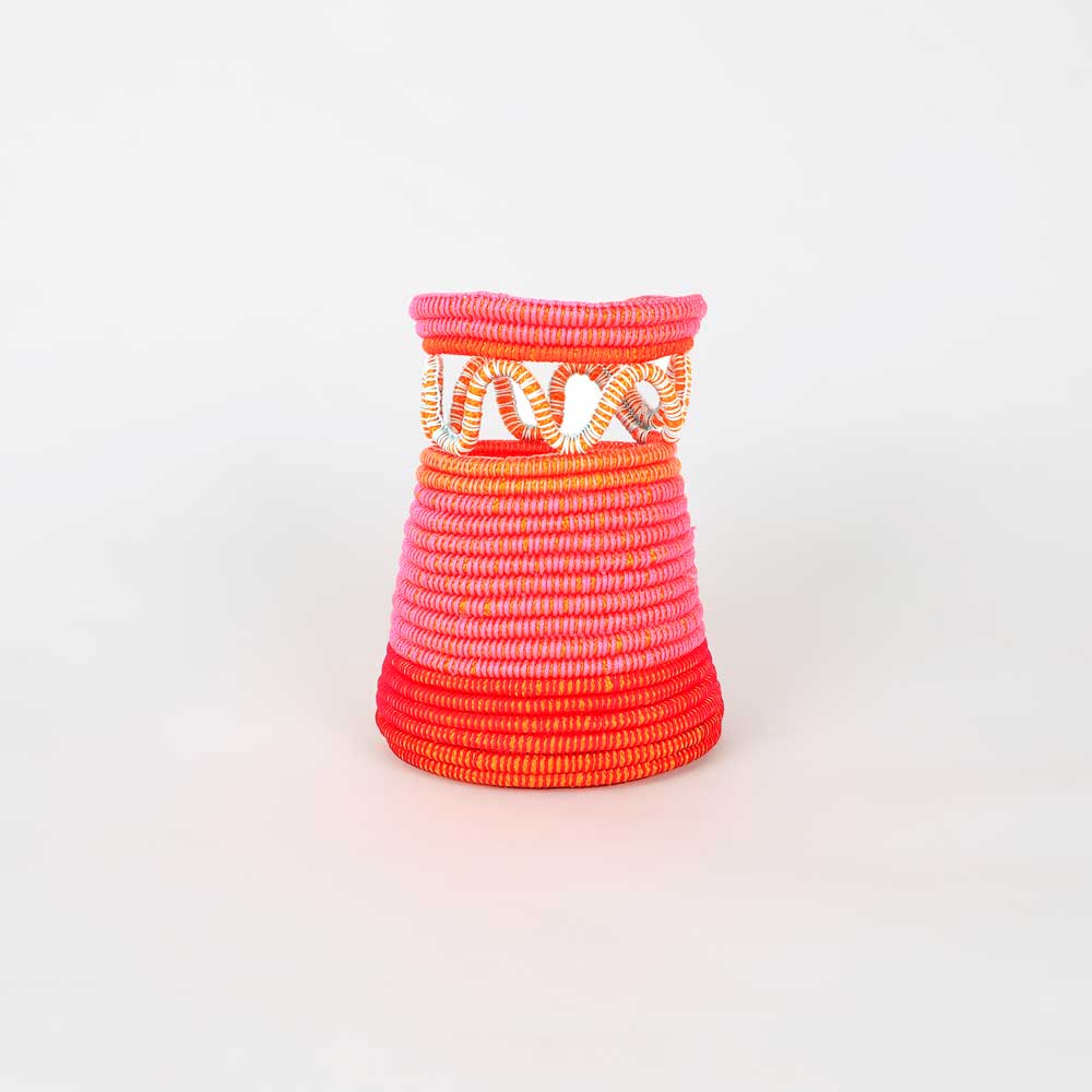 Black, Pink and Orange Woven Bag on white background by artist Sophie Holness on white background